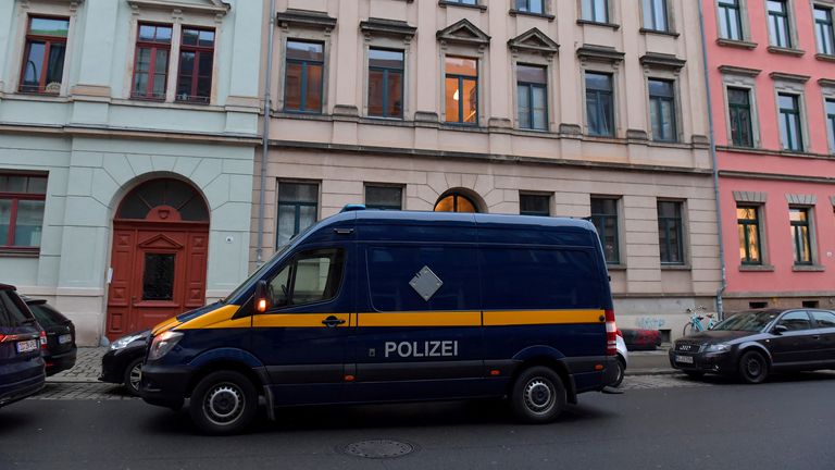 A police vehicle is parked in front of a building during raids in several locations in Dresden, Germany, December 15, 2021, as part of an investigation into what they said was a plot to murder the state&#39;s prime minister, Michael Kretschmer, by anti-vaccination activists. The searches in the city of Dresden targeted individual members of a group on the messaging program Telegram, where plans for the killing were discussed in connection with the state government&#39;s coronavirus curbs, police said. 