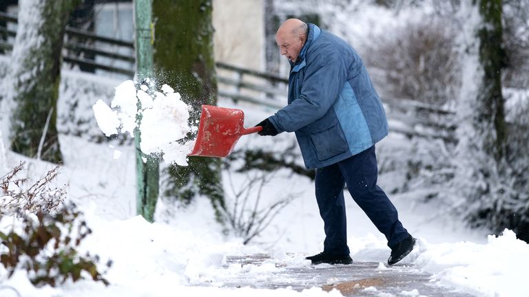A man clears snow away in Leadhills, South Lanarkshire as Storm Barra hits the UK and Ireland with disruptive winds, heavy rain and snow on Tuesday. Picture date: Tuesday December 7, 2021.

