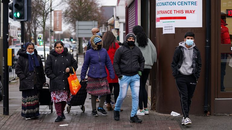 People queue at Melton Road Vaccination Centre in Leicester, as the coronavirus booster vaccination programme is ramped up to an unprecedented pace of delivery, with every eligible adult in England being offered a top-up injection by the end of December. Picture date: Monday December 20, 2021.
