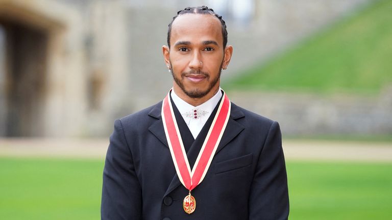 Lewis Hamilton poses for a photo after he was made a Knight Bachelor by Britain&#39;s Charles, Prince of Wales, during an investiture ceremony at Windsor Castle in Windsor, Britain, December 15, 2021. Andrew Matthews/Pool via REUTERS
