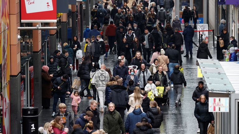People walk along a busy shopping street as people search for deals on traditional Boxing Day sale in Liverpool, Britain, December 26, 2021. REUTERS/Phil Noble