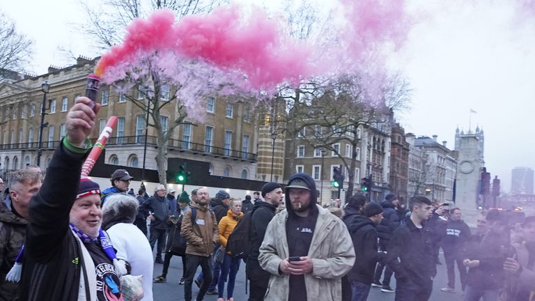 Protestors set off smoke flares during the 