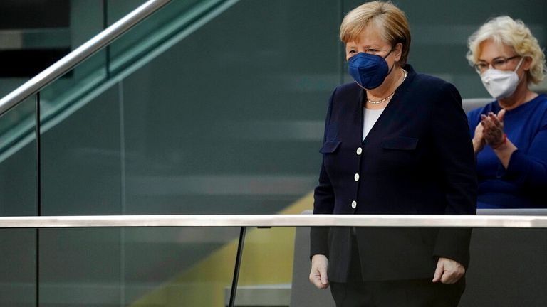 08 December 2021, Berlin: Chancellor Angela Merkel (l, CDU), still in office, stands in the gallery before the election of the Chancellor. The election and swearing-in of Scholz as Chancellor and the swearing-in of the federal ministers of the new red-green-yellow federal government take place in the Bundestag. Photo: Kay Nietfeld/dpa