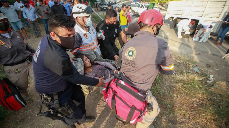 یک زن مهاجر زخمی توسط نیروهای امدادی از صحنه خارج شد.  عکس: AP