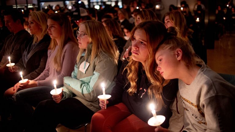 Emerson Miller, right, leans on her friend Joselyn&#39;s shoulder as they listen to Jessi Holt, pastor at LakePoint Community Church, during a prayer vigil at the church after the Oxford High School school shooting, Tuesday, Nov. 30, 2021, in Oxford, Mich. (Jake May/The Flint Journal via AP)
