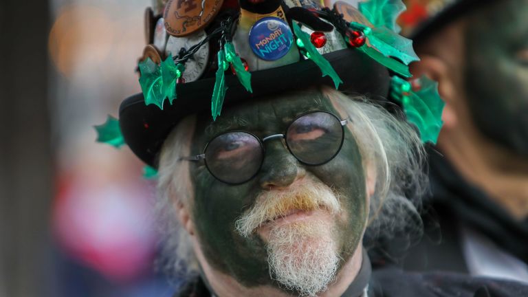 Morris dancer performing in green face paint outside.The Market House, Ledbury, Herefordshire. Pic: SWNS