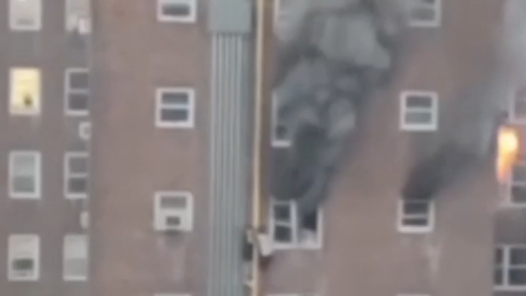 The two people grabbed on to each other for support as they scaled down the building