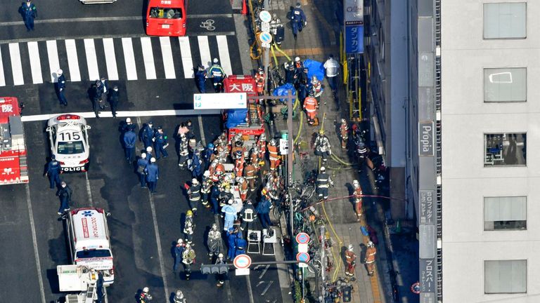 Photo taken from a Kyodo News helicopter shows firefighters and police officers gathering in front of a building in Osaka where a fire broke out on the fourth floor on Dec. 17, 2021. Twenty-seven people are feared dead. 
Pic:Kyodo via AP Images