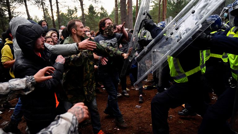 Revellers clash with riot police at the scene of a suspected illegal rave in Thetford Forest, in Norfolk, Britain, August 30, 2020. REUTERS/Toby Melville
