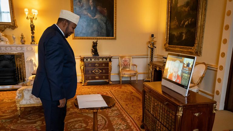 Queen Elizabeth II appears on a screen via videolink from Windsor Castle during a virtual audience with the Ambassador of Somalia, Abdulkadir Ahmed Kheyr Abdi.