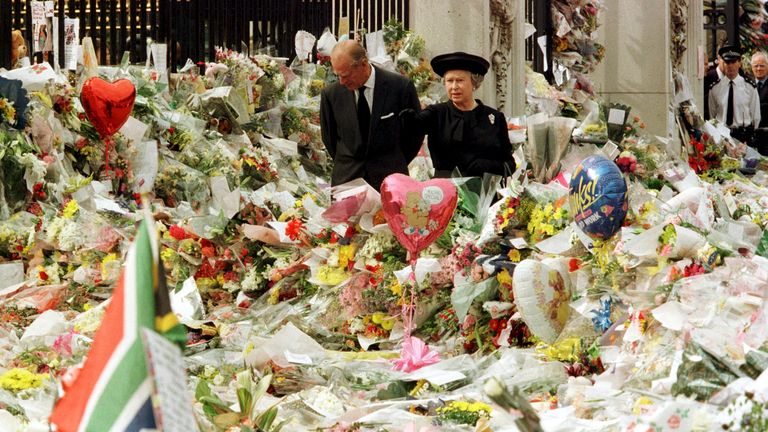 The Queen and Duke of Edinburgh walk among a sea of flowers left outside Kensington Palace on 5 September 1997