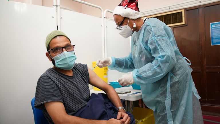A man receives a &#39;Jingle Jab&#39; Covid vaccination booster injection at Redbridge Town Hall, in Ilford, Essex, as the coronavirus booster programme continues across the UK on Christmas day. Picture date: Thursday December 23, 2021.
