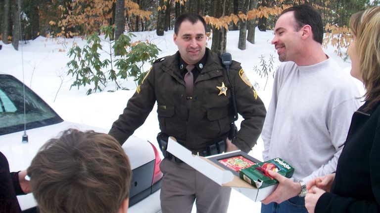  A box of "Santa&#39;s Book of Candy," is delivered to Eric Wasson by Carroll County Sheriff&#39;s Deputy Tom Riley, center, as a re-gift from Ryan Wasson during Christmas time in 2007
PIC:AP