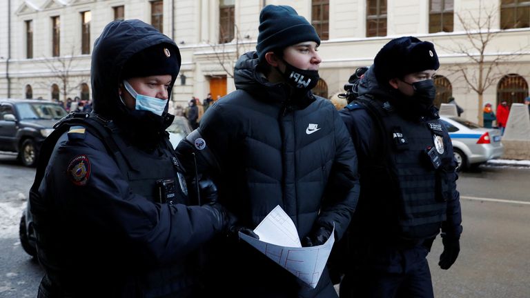 Des policiers escortent un partisan du groupe de défense des droits humains International Memorial hors d'une audience de la Cour suprême russe 
