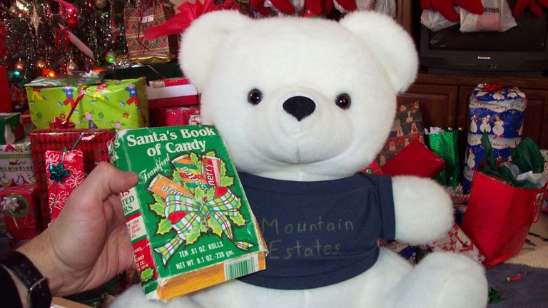 s Ryan Wasson family photograph, a box of "Santa's Book of Candy," which was sewn inside the gift toy bear by Eric Wasson, is held by Ryan Wasson at Christmas in December 2004 PIC:AP