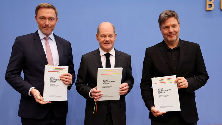 The SDP&#39;s Olaf Scholz, who is due to become chancellor, the FDP&#39;s Christian Lindner, designated Finance Minister and the Greens&#39; Robert Habeck, due to be Economy and Climate Minister, at the signing ceremony