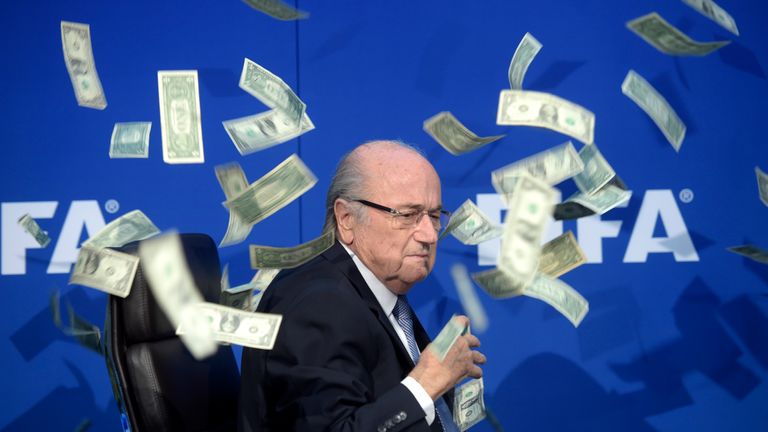 British comedian Simon Brodkin carried out a protest during a FIFA news conference showering then president Sepp Blatter with cash. Pic: AP