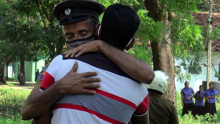 A Sri Lankan police officer consoles a relative of a victimised police officer in a shoot out inside a police station in Thirukkovil, east of Colombo, Sri Lanka, Saturday, Dec. 25, 2021. A policeman opened fire on a group of fellow officers in Sri Lanka, killing four of them and wounding three others, a police spokesman said Saturday.(AP Photo/Achala Pussalla)..
PIC:AP