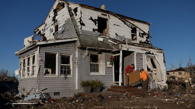Men salvage furniture in the aftermath of a tornado in Mayfield, Kentucky, U.S., December 13, 2021. REUTERS/Adrees Latif