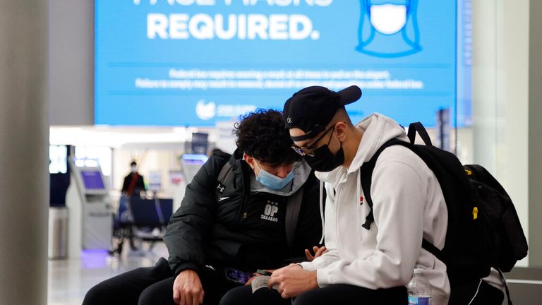 Virus Outbreak Ohio
Youssef, left, and Omar Shaaban, brothers from Dublin, Ohio, wait to check in for their flight at John Glenn Columbus International Airport Wednesday, Dec. 22, 2021, in Columbus, Ohio. (AP Photo/Jay LaPrete)