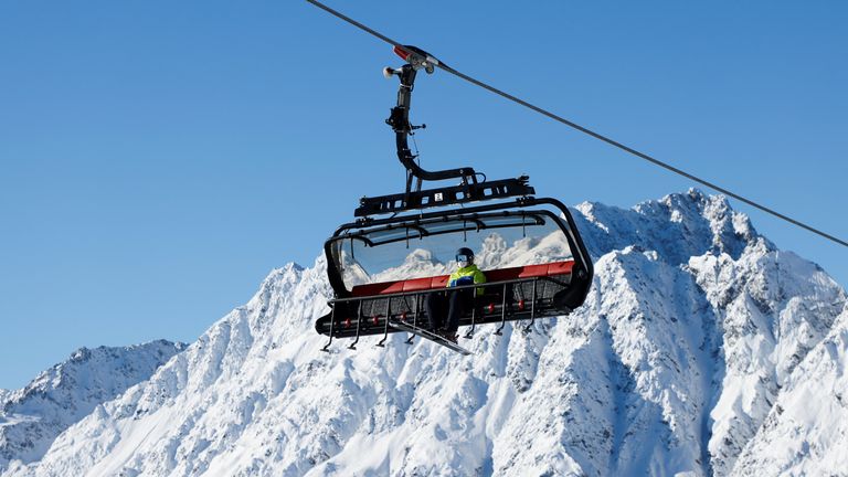 Skiers sit on a chairlift as ski season opens during the fourth national coronavirus disease (COVID-19) lockdown in Ischgl, Austria, December 3, 2021. REUTERS/Leonhard Foeger
