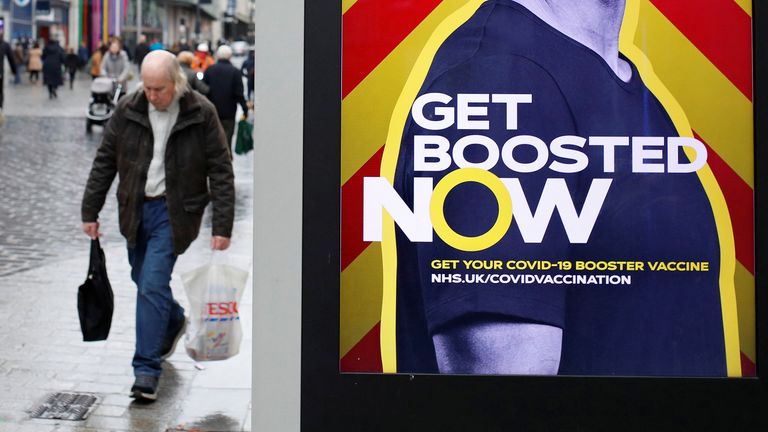 A man walks past an advertising board encouraging people to get their booster vaccination, amid the coronavirus disease (COVID-19) outbreak in Liverpool, Britain, December 29, 2021. REUTERS / Phil Noble