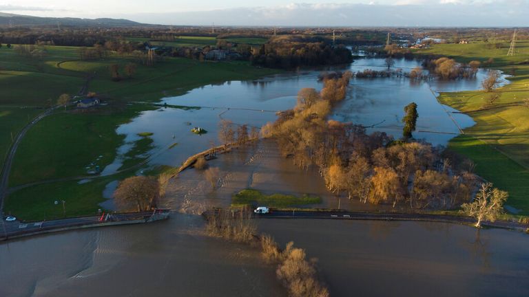 Llanerch Bridge over the flooded river Clwyd near Saint Asaph in north Wales is seen after large parts of central and northern England and Wales were caught in the path of Storm Christoph, Saint Asaph, Wales, Thursday Jan. 21, 2021. ( AP Photo Jon Super)