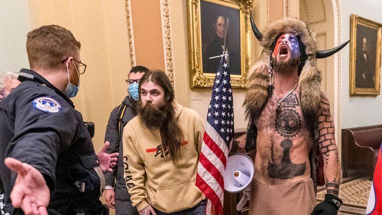 Jacob Chansley (R), known as the &#39;QAnon Shaman&#39;, was jailed over the riot