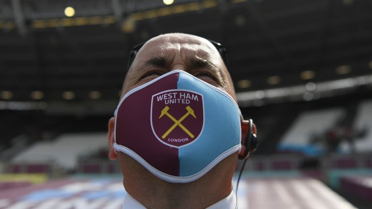 A steward at West Ham United wears a face mask  Pic Associated Press 