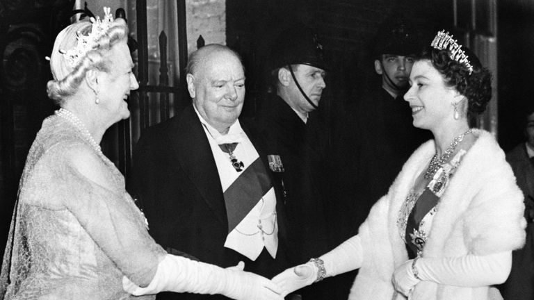 Queen Elizabeth II is greeted by Lady Churchill and Sir Winston Churchill, as she arrives for a dinner party at No. 10 Downing Street.