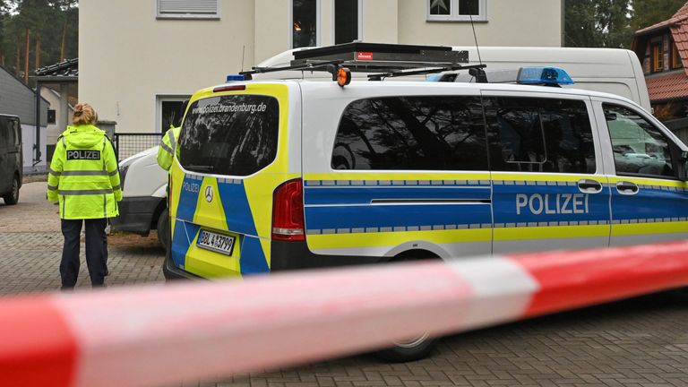 Police have cordoned off a single-family home in Senzig, a district of the town of Kownigs Wusterhausen in the Dahme-Spreewald district, Saturday, Dec.4, 2021. Police found five dead bodies in a home there. The police assume a homicide, a spokesman said. (Patrick Pleul/dpa via AP)