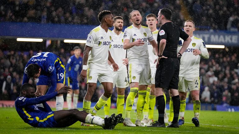 Chelsea&#39;s Antonio Rudiger lies on the ground as Leeds United players argue with referee Chris Kavanagh during the Premier League match between Chelsea and Leeds United at Stamford Bridge on Dec.11, 2021. (AP Photo/Matt Dunham)