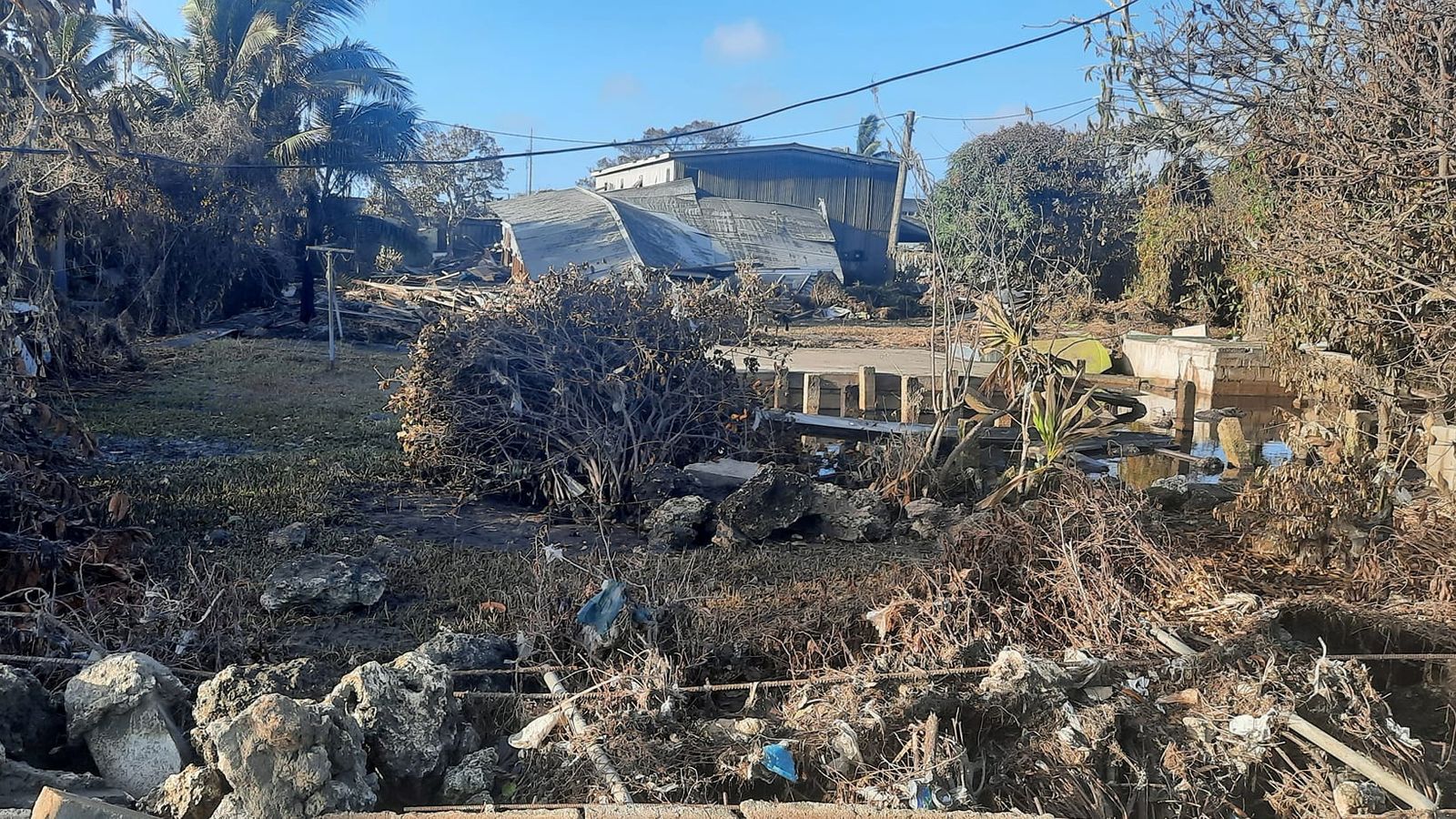 Tonga: First foreign aid planes arrive as new photos show tsunami devastation