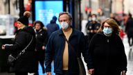 Shoppers wear protective face masks as they walk on Oxford Street, as rules on wearing face coverings in some settings in England are relaxed, amid the spread of the coronavirus disease (COVID-19) pandemic, in London, Britain, January 27, 2022. REUTERS/Toby Melville
