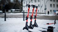 Electric scooters are seen during a snowfall in Dortmund, Germany, February 10, 2021.