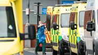 A paramedic at the rear of an ambulance outside the Royal London Hospital in London