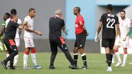 Tunisia&#39;s head coach Mondher Kebaier, center left, gestures to the referee Janny Sikazwe of Zambia, during the African Cup of Nations 2022 group F soccer match between Tunisia and Mali at the Limbe Omnisport Stadium in Limbe, Cameroon, Wednesday, Jan. 12, 2022. (AP Photo/Sunday Alamba)


