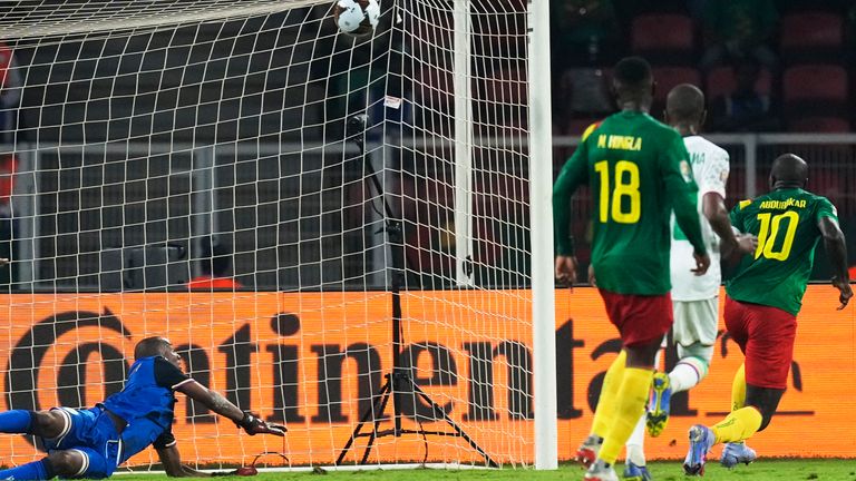 Comoros&#39; goalkeeper Chaker Alhadhur, left, fails to stop a goal shot from Cameroon&#39;s Vincent Aboubakar, far right, during the African Cup of Nations 2022 round of 16 soccer match between Cameroon and Comoros at the Olembe stadium in Yaounde, Cameroon, Monday, Jan. 24, 2022. (AP Photo/Themba Hadebe)


