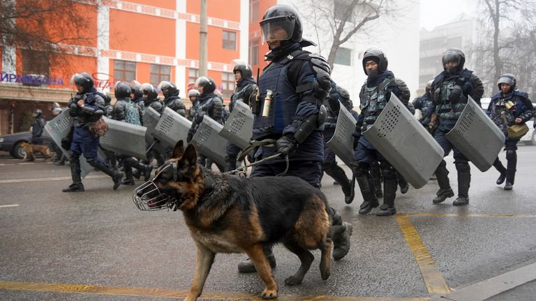 Riot police walk to block demonstrators gathering during a protest in Almaty. Pic: AP