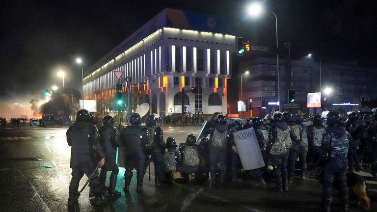 Riot police take up position in Almaty. Pic: AP