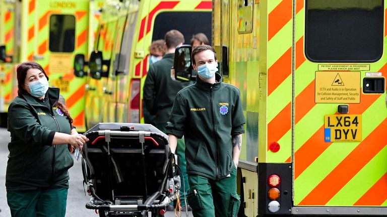 FILE PHOTO: Health workers move equipment between ambulances outside of the Royal London Hospital, amid the coronavirus disease (COVID-19) pandemic in London, Britain, January 7, 2022. REUTERS/Toby Melville/File Photo
