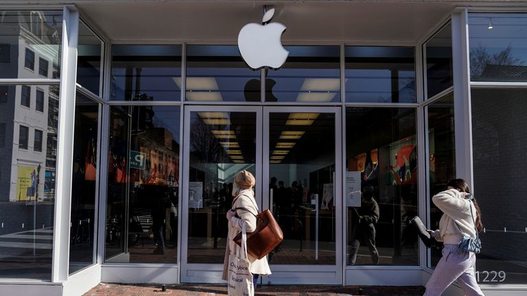 Pedestrians walk past an Apple store as Apple Inc. reports fourth quarter earnings in Washington, U.S., January 27, 2022.