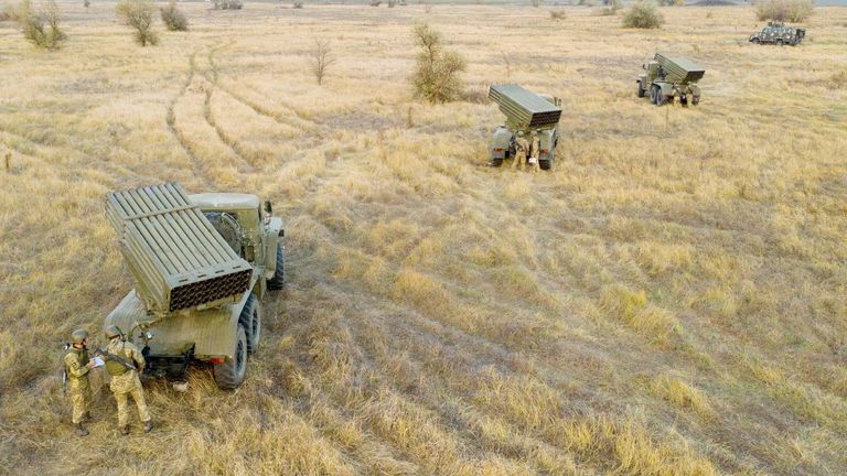 Service members of the Ukrainian Armed Forces gather near vehicles, including BM-21 "Grad" multiple rocket launchers, during tactical military exercises at a shooting range in the Kherson region, Ukraine, January 19, 2022. Picture taken January 19, 2022. Ukrainian Defence Ministry/Handout via REUTERS ATTENTION EDITORS - THIS IMAGE HAS BEEN SUPPLIED BY A THIRD PARTY.
