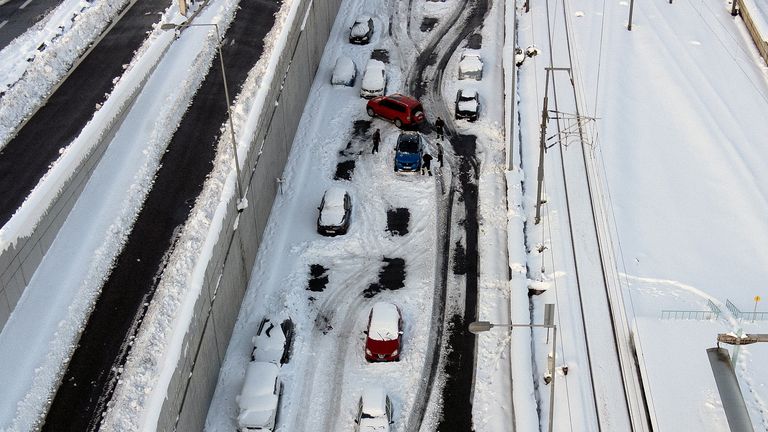 Firemen plough snow around a car as abandoned vehicles are covered in snow on the Attiki Odos motorway, following heavy snowfall in Athens, Greece, January 25, 2022. Picture taken with a drone. REUTERS/Alkis Konstantinidis
Firemen plough snow around a car as abandoned vehicles are covered in snow on the Attiki Odos motorway, following heavy snowfall in Athens, Greece, January 25, 2022. Picture taken with a drone. REUTERS/Alkis Konstantinidis
