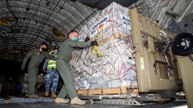 Australian Defence Forces members unload humanitarian assistance and engineering equipment from an aircraft at Fua&#39;amotu International Airport, Tonga, January 20, 2022. Australian Department Of Defence/Handout via REUTERS THIS IMAGE HAS BEEN SUPPLIED BY A THIRD PARTY. NO RESALES. NO ARCHIVES
