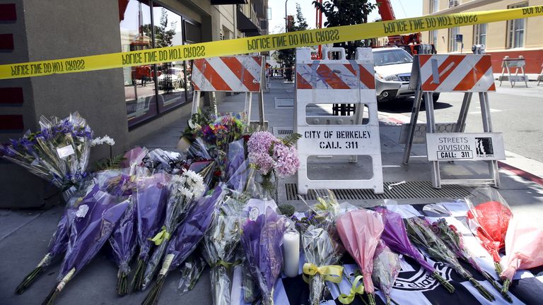 Flowers are laid at a memorial near the scene of a 4th-story apartment building balcony collapse in Berkeley in 2015