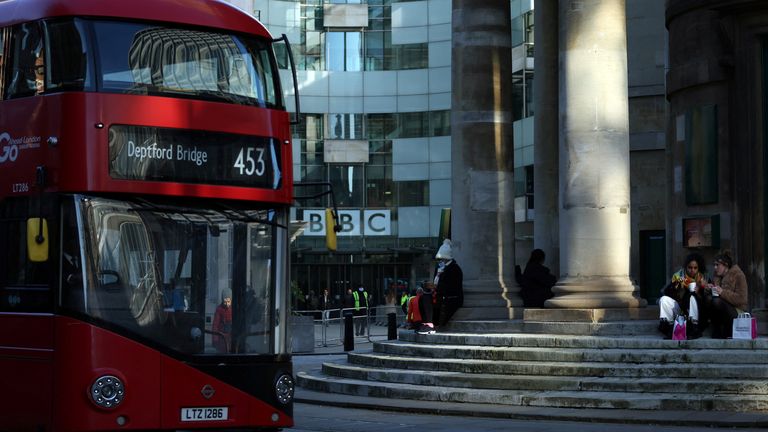 People sit outside the BBC Broadcasting House offices and recording studios in London, Britain, January 17, 2022.REUTERS/Hannah McKay
