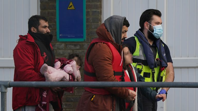 Suspected migrants are escorted by Border Force officials in Dover
