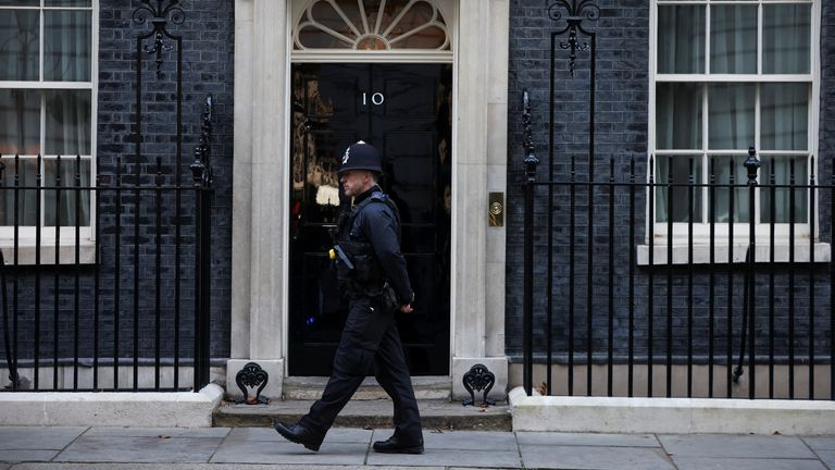 A police officer walks outside Downing Street in London, Britain, January 31, 2022. REUTERS/Henry Nicholls
