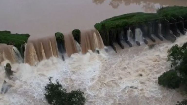 Water flows over the Carioca dam in Brazil, threatening to destroy it  